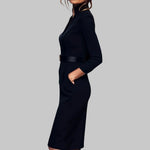 Black dress worn by a person on a gray background