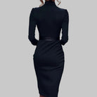 Black dress with a belt on a gray background