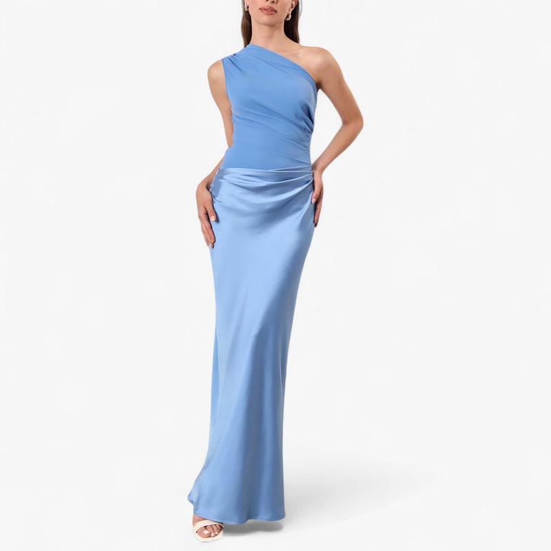 Women’s asymmetric maxi dress in blue with delicate pleats, flowing and elegant for weddings and formal events.