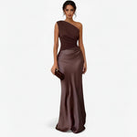 Women’s asymmetric maxi dress in brown with delicate pleats, flowing and elegant for weddings and formal events.