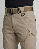 Men’s outdoor pants in khaki with weather-resistant fabric, ergonomic design, and elastic cuffs for trekking, hiking, and climbing.