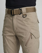 Men’s outdoor pants in khaki with weather-resistant fabric, ergonomic design, and elastic cuffs for trekking, hiking, and climbing.