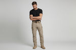 Men’s outdoor pants in khaki with weather-resistant fabric, ergonomic design, and elastic cuffs for trekking, hiking, and climbing.