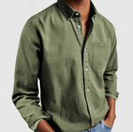 Green button-up shirt worn by a person on a light gray background