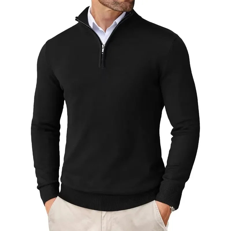 Black quarter-zip sweater worn by a person on a white background