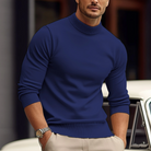 Man wearing a blue sweater with a blurred background