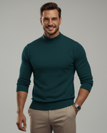 Man wearing a teal sweater with a blurred background