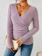 Women’s pink tummy-tucking long sleeve V-neck top with flattering fit and soft stretch fabric.