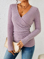 Women’s pink tummy-tucking long sleeve V-neck top with flattering fit and soft stretch fabric.
