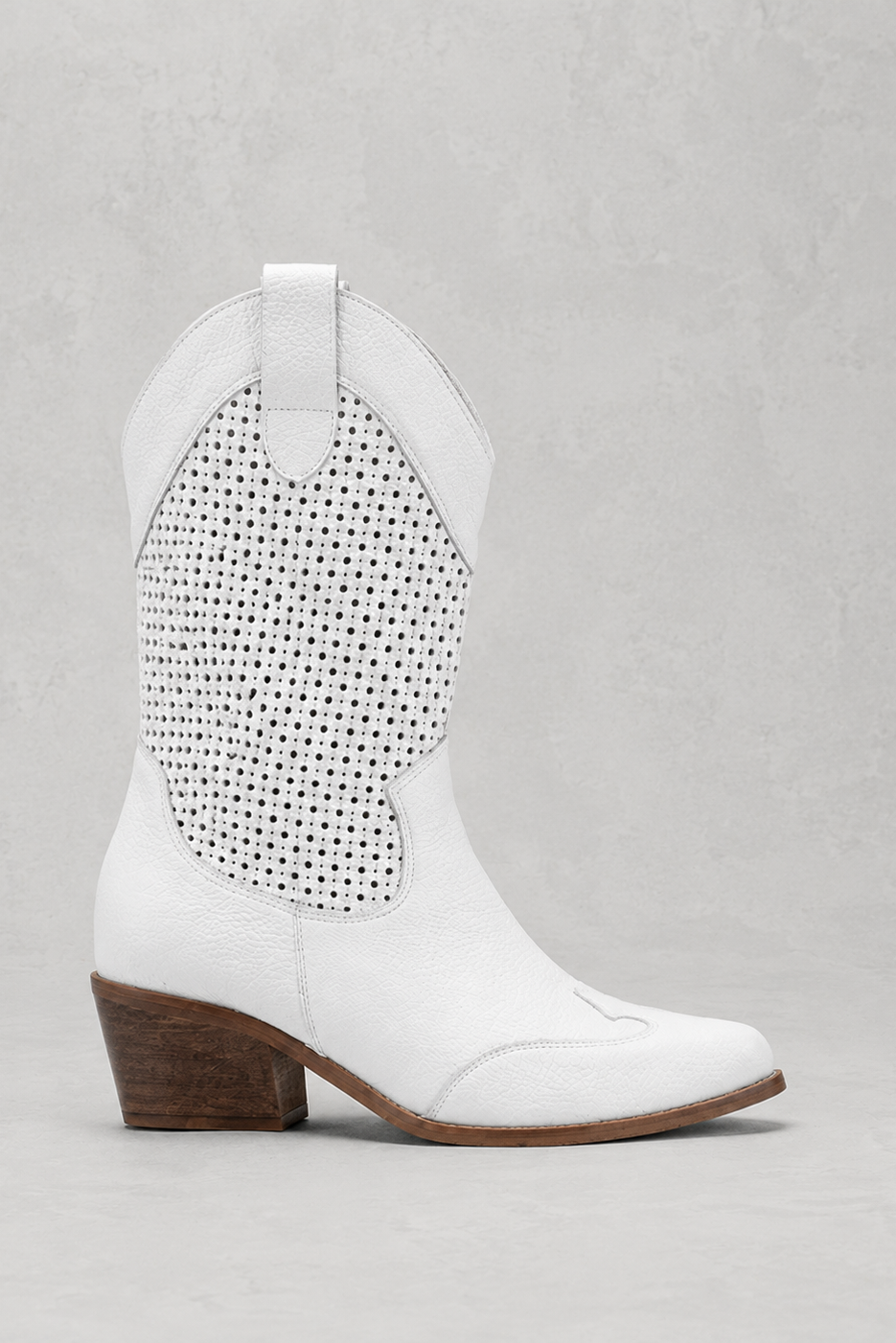 White cowboy boot with studded detail on a light gray background