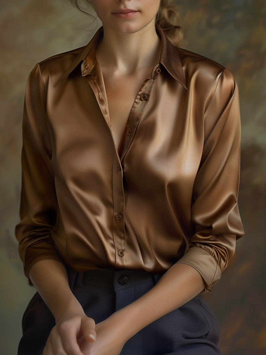 Brown satin shirt worn by a person against a neutral background
