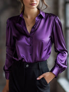 Purple satin shirt worn by a person with a blurred background