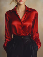 Red satin shirt worn by a person on a neutral background