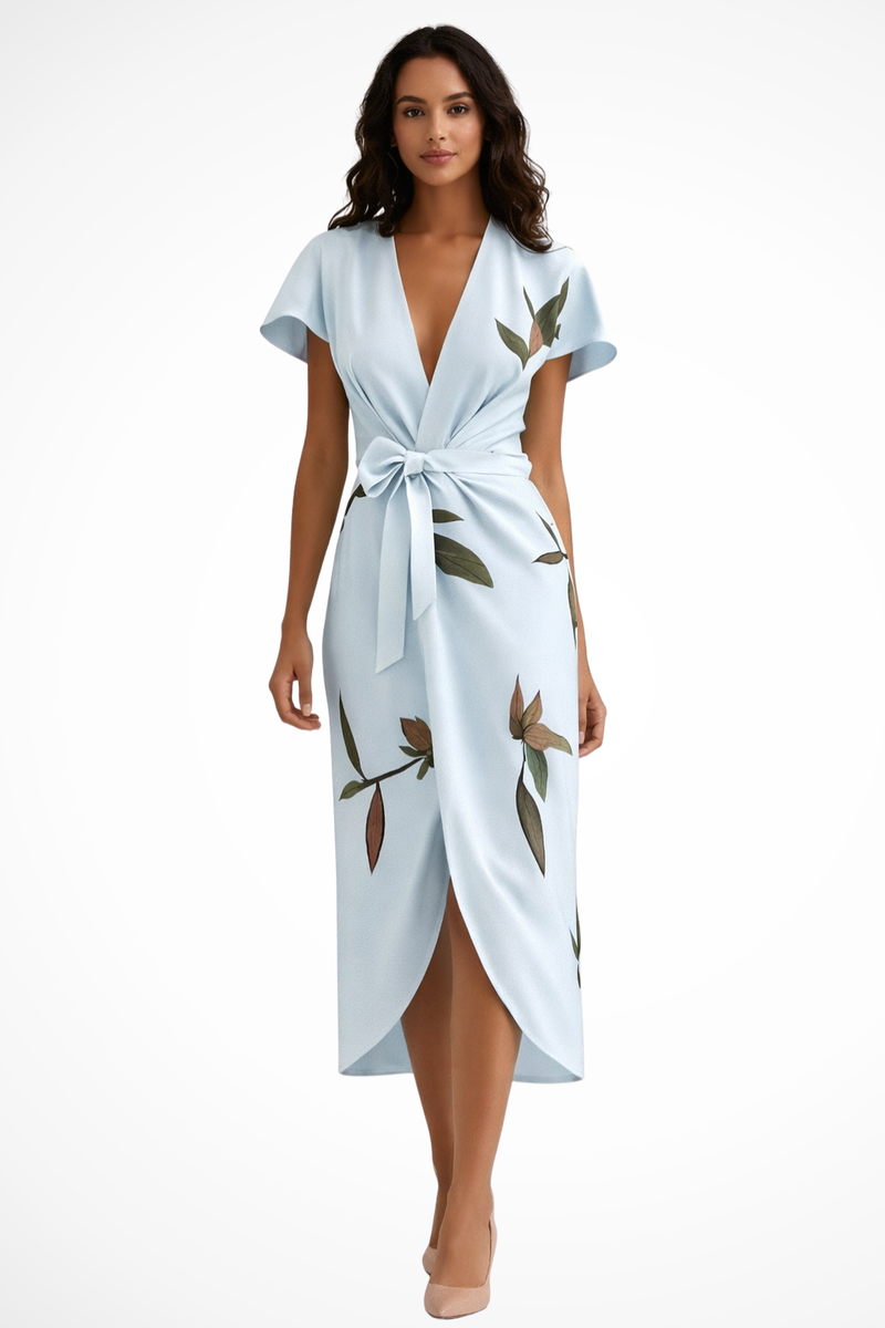 Woman wearing a light blue dress with floral patterns on a white background