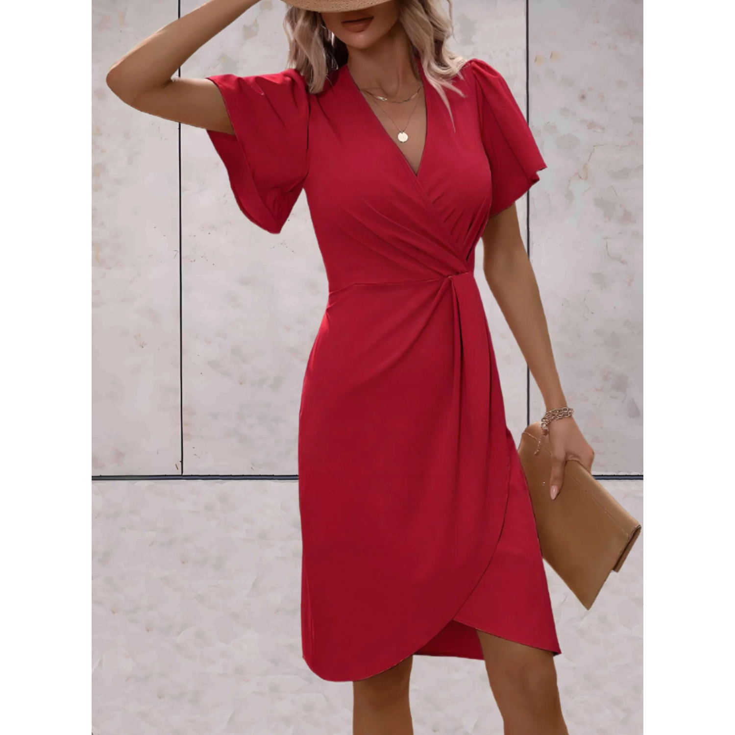 Woman wearing a red dress with a neutral background