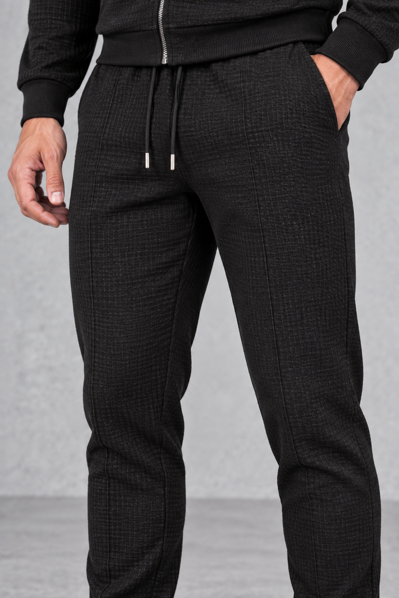 Men’s textured two-piece tracksuit with a full-zip collared jacket, ribbed trims and matching tapered drawstring joggers.