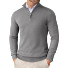 Man wearing a gray quarter-zip sweater on a white background