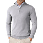 Man wearing a gray quarter-zip sweater on a white background