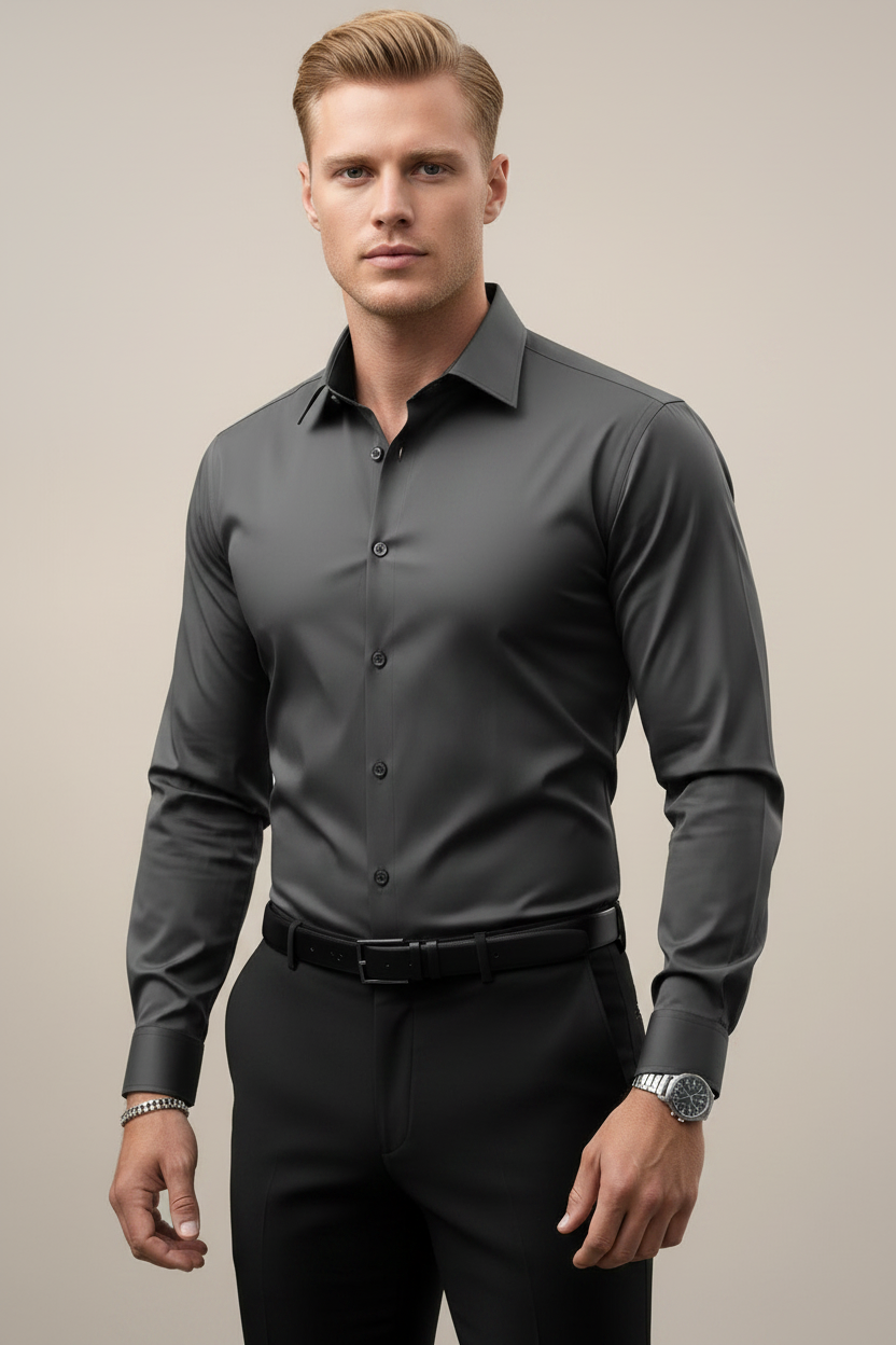 Man wearing a gray dress shirt and black pants against a neutral background