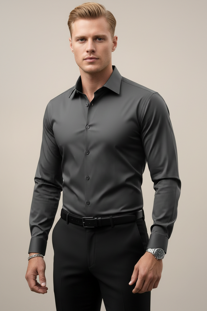 Man wearing a gray dress shirt and black pants against a neutral background