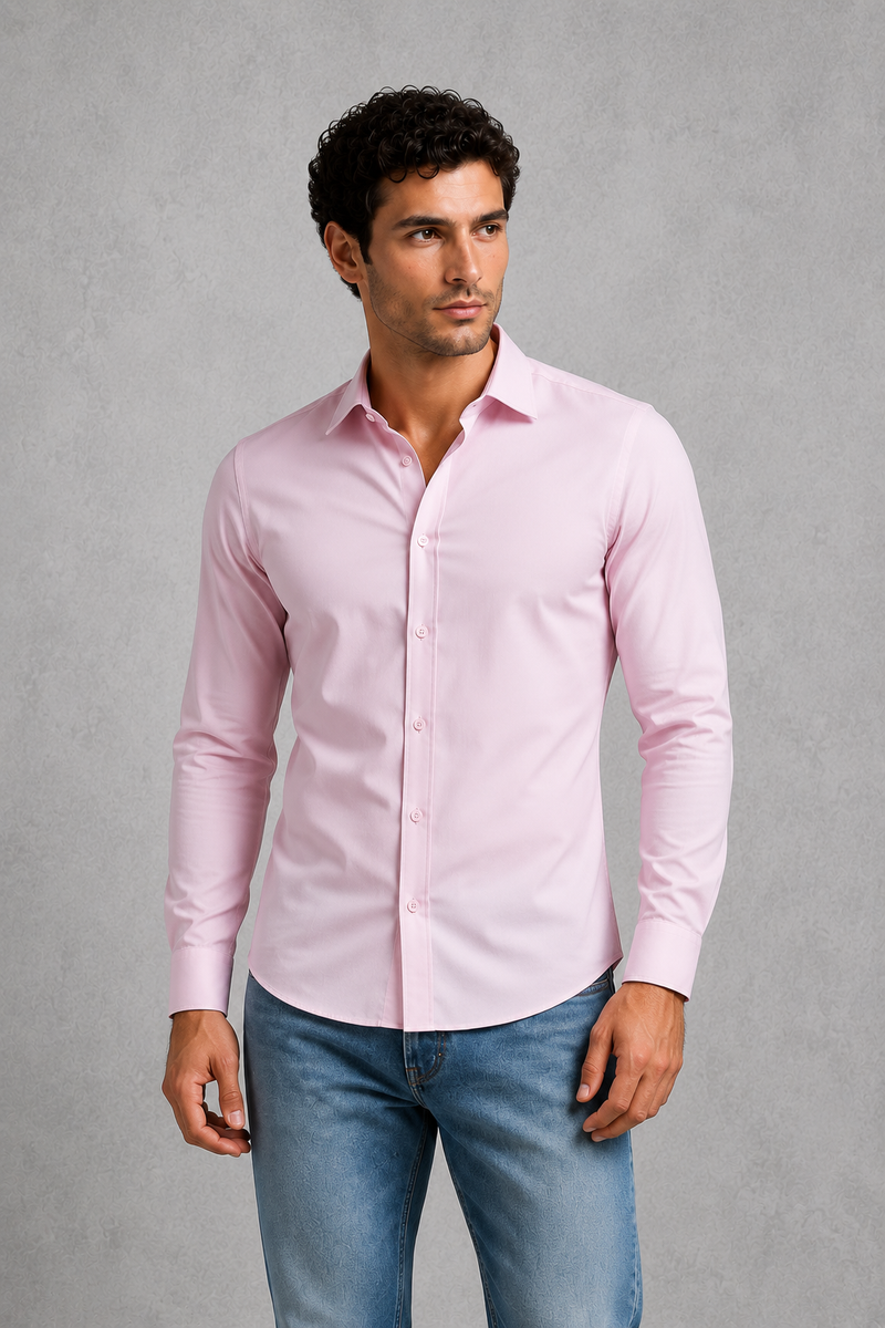 Man wearing a light pink dress shirt and blue jeans against a gray background