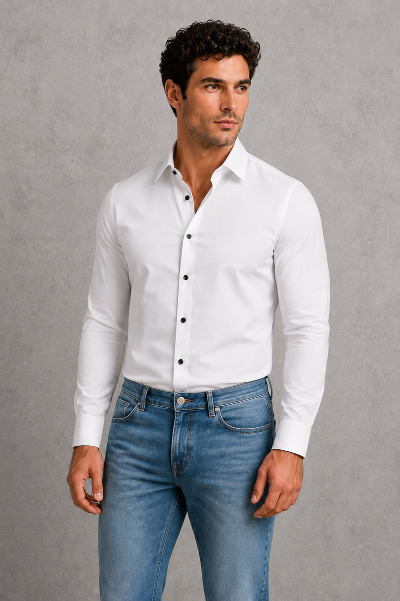 Man wearing a white dress shirt and blue jeans against a gray background