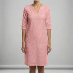 Pink dress with floral pattern on a gray background
