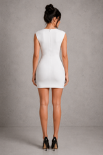 Woman wearing a white dress against a gray background
