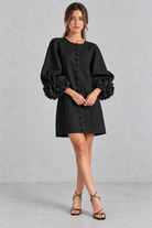 Women’s cotton-linen mini dress with 3D floral detailing, round neckline, long lantern sleeves and a loose A-line silhouette.