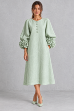 Women’s long dress with 3D floral detailing, round neckline, statement lantern sleeves, button accents and a loose A-line silhouette.
