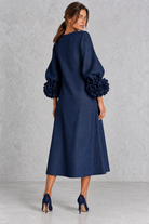 Women’s long dress with 3D floral detailing, round neckline, statement lantern sleeves, button accents and a loose A-line silhouette.