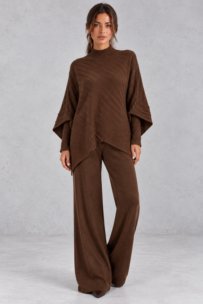 Women’s ribbed knit two-piece set with an asymmetric high-neck jumper, draped crossover hem and matching wide leg trousers.