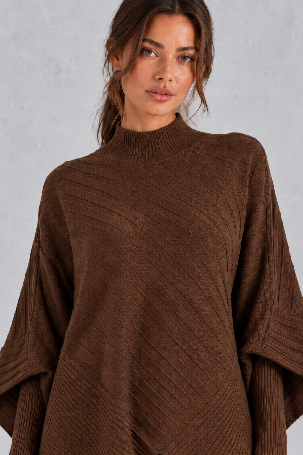 Women’s ribbed knit two-piece set with an asymmetric high-neck jumper, draped crossover hem and matching wide leg trousers.