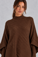 Women’s ribbed knit two-piece set with an asymmetric high-neck jumper, draped crossover hem and matching wide leg trousers.