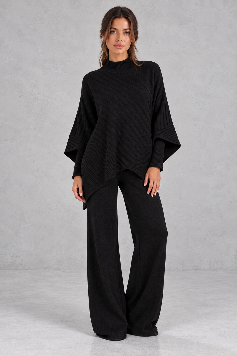 Women’s ribbed knit two-piece set with an asymmetric high-neck jumper, draped crossover hem and matching wide leg trousers.