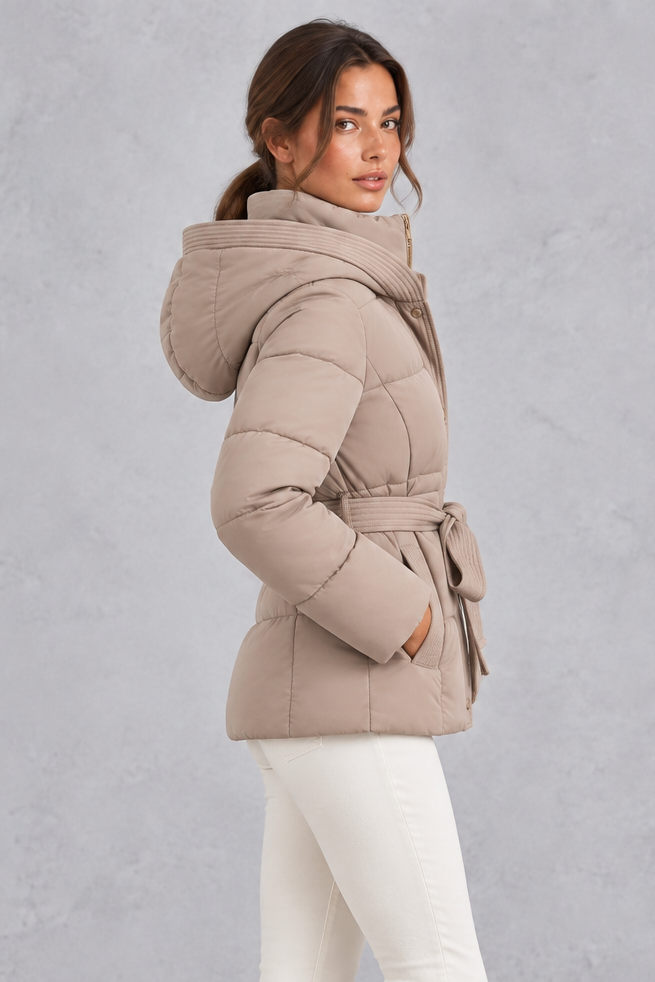 Women’s belted hooded quilted puffer jacket with warm padding, a high neckline, adjustable tie waist and practical side pockets.