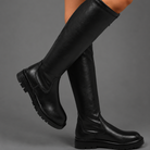 Women’s black faux leather mid-calf boots with pointed toes, low 3 cm heels and inside zip fastening.