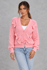 Women’s knitted cardigan with decorative fabric bows, a V-neckline, button front, textured knit finish and slightly cropped silhouette.