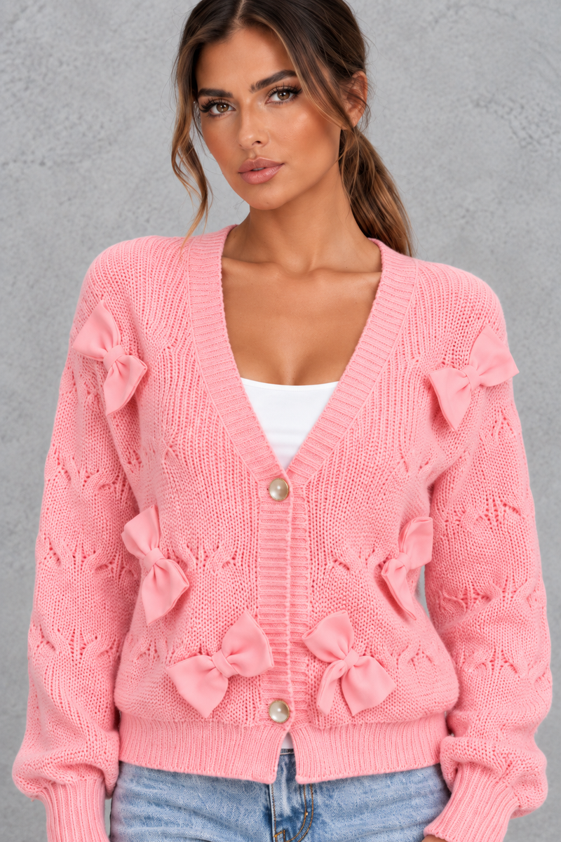 Women’s knitted cardigan with decorative fabric bows, a V-neckline, button front, textured knit finish and slightly cropped silhouette.