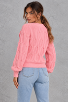 Women’s knitted cardigan with decorative fabric bows, a V-neckline, button front, textured knit finish and slightly cropped silhouette.