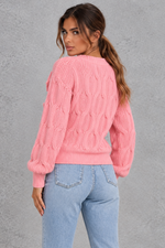 Women’s knitted cardigan with decorative fabric bows, a V-neckline, button front, textured knit finish and slightly cropped silhouette.