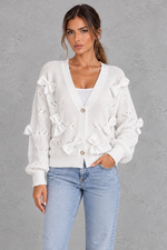 Women’s knitted cardigan with decorative fabric bows, a V-neckline, button front, textured knit finish and slightly cropped silhouette.