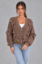 Women’s knitted cardigan with decorative fabric bows, a V-neckline, button front, textured knit finish and slightly cropped silhouette.