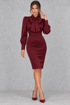 Women’s bow neck midi bodycon dress with elegant tie detailing, long puff sleeves and a sleek fitted silhouette.