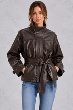 Women’s brown faux leather cropped jacket with a classic lapel collar, long sleeves and an adjustable belted waist.