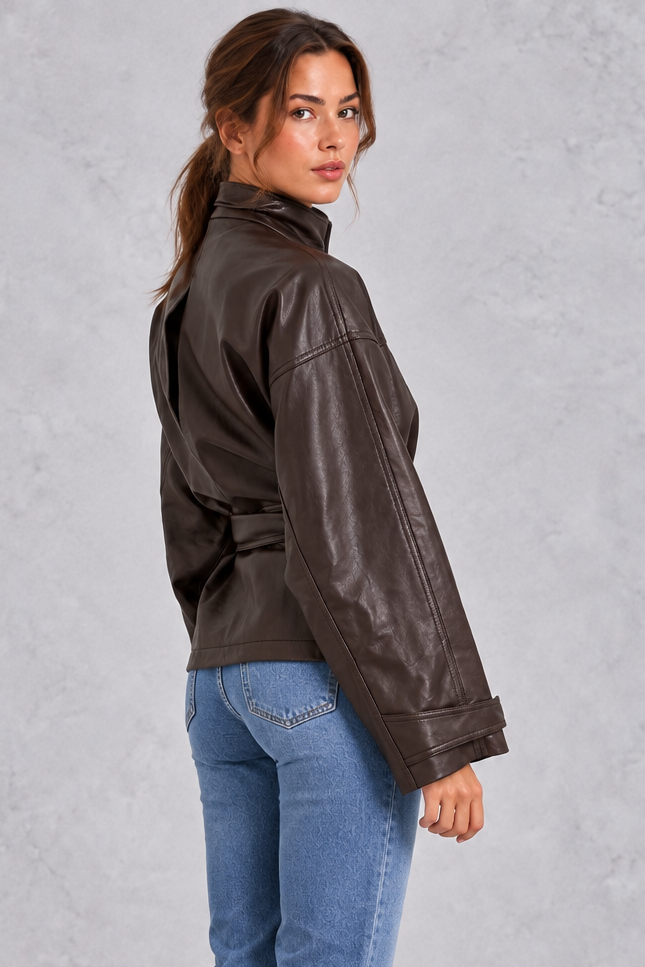 Women’s brown faux leather cropped jacket with a classic lapel collar, long sleeves and an adjustable belted waist.