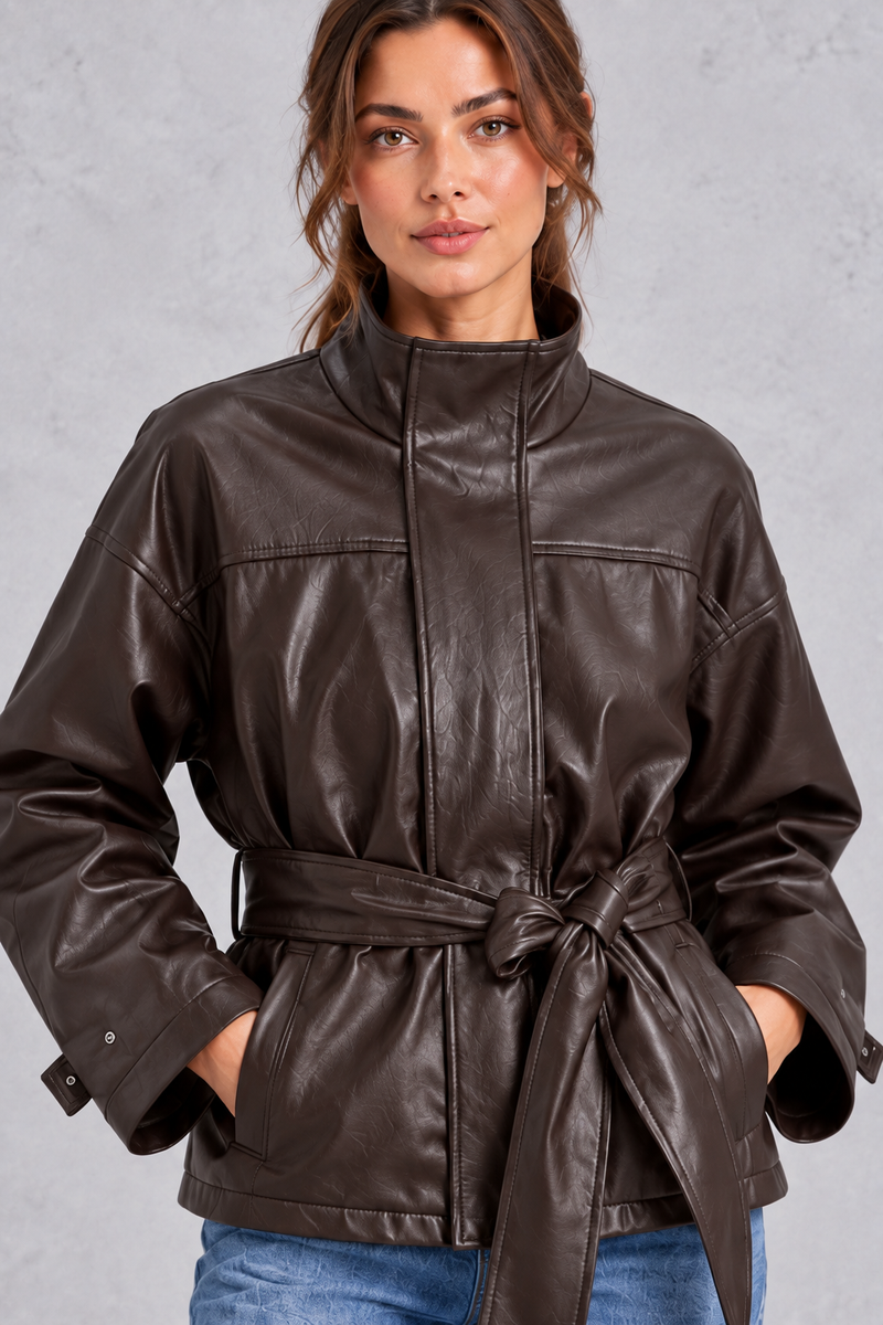 Women’s brown faux leather cropped jacket with a classic lapel collar, long sleeves and an adjustable belted waist.