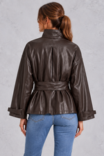 Women’s brown faux leather cropped jacket with a classic lapel collar, long sleeves and an adjustable belted waist.