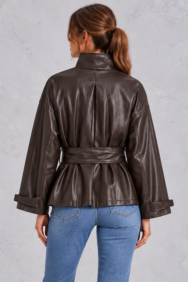 Women’s brown faux leather cropped jacket with a classic lapel collar, long sleeves and an adjustable belted waist.
