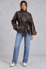 Women’s brown faux leather cropped jacket with a classic lapel collar, long sleeves and an adjustable belted waist.